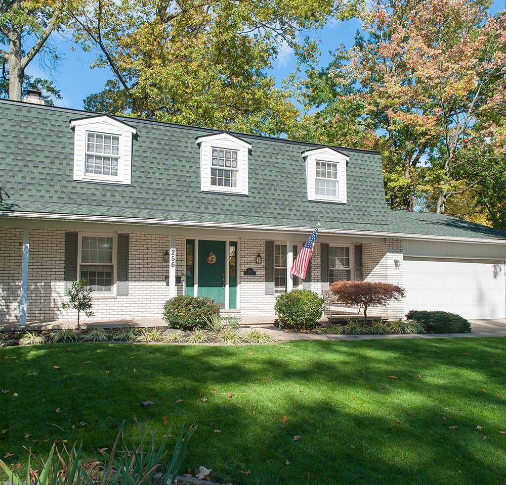 suburban house surrounded by mature trees
